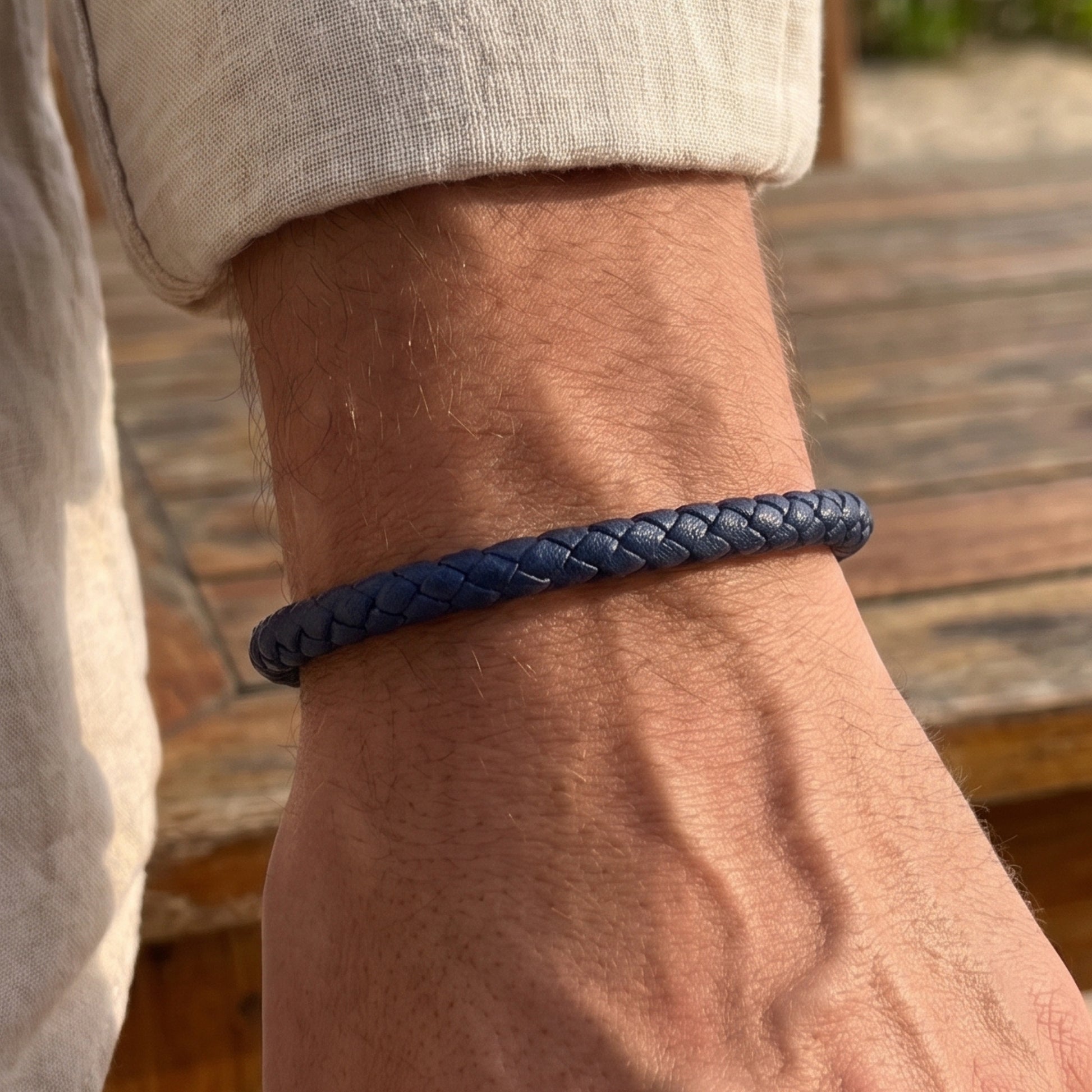 Men's dark blue braided leather bracelet worn on wrist