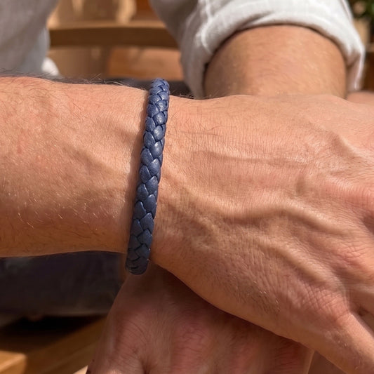 Dark blue braided leather bracelet worn on male wrist