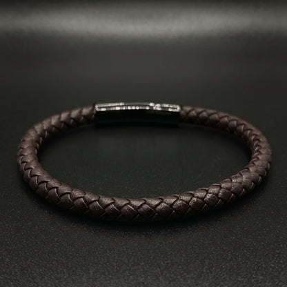 Braided leather bracelet showing rectangular metal clasp and shiny top detail