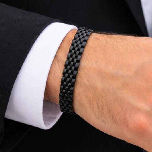 Men's black stainless steel link bracelet with braided chain pattern on wrist