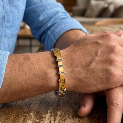 Two-tone stainless steel bracelet on forearm, gold centerpiece with silver links