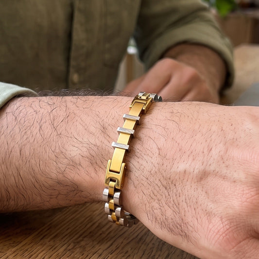 Two-tone stainless steel bracelet on wrist, gold square links and silver bands