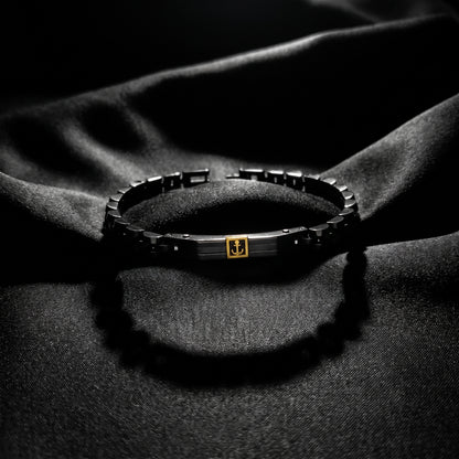 Men's stainless steel bracelet with black links and gold anchor centerpiece