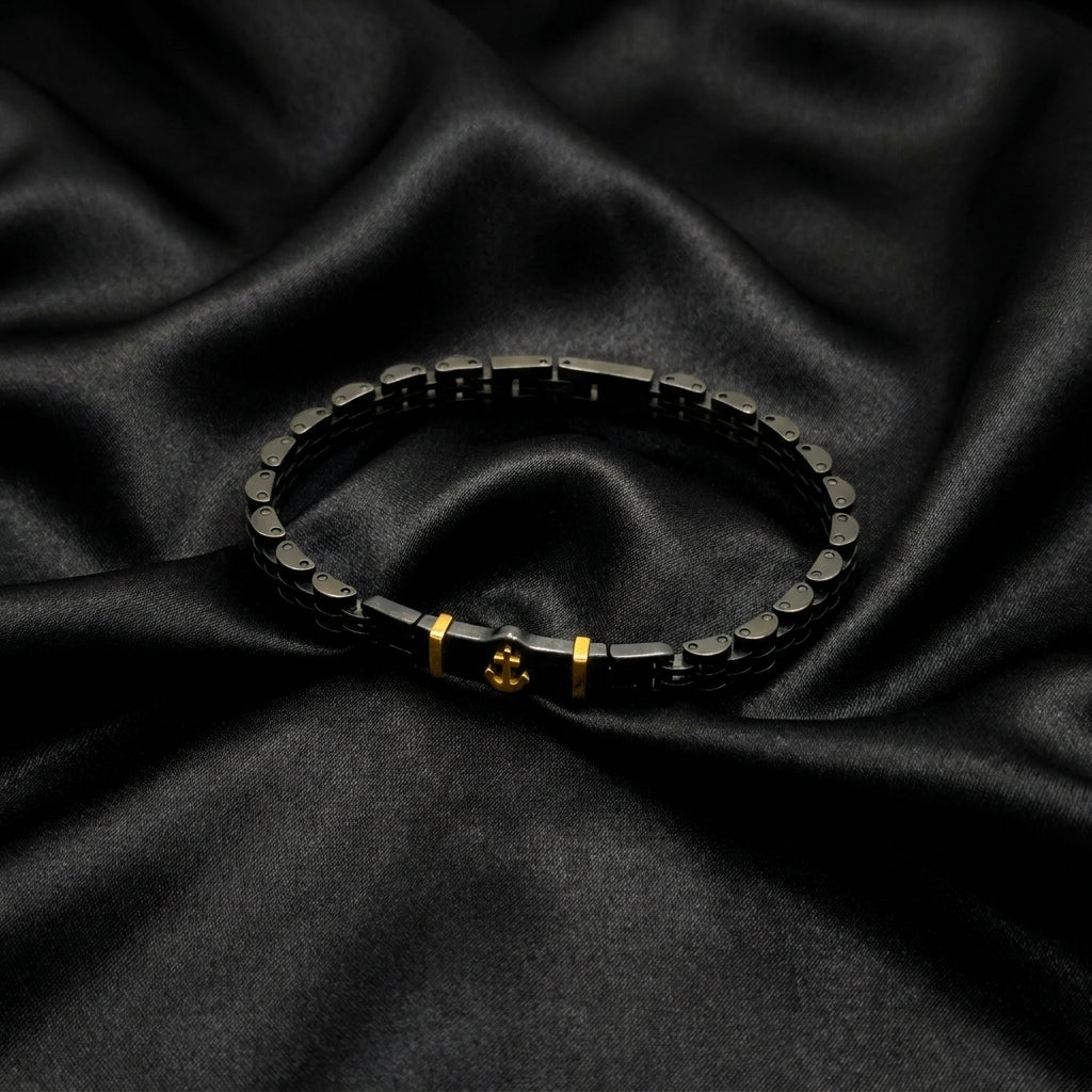 Black & Gold Anchor Stainless Steel B-145 Bracelet by Overpowered Accessories, featuring a sleek design on a dark fabric back