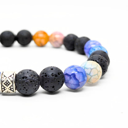 Men's gemstone bracelet close-up with black lava beads, blue and orange agate, silver charm