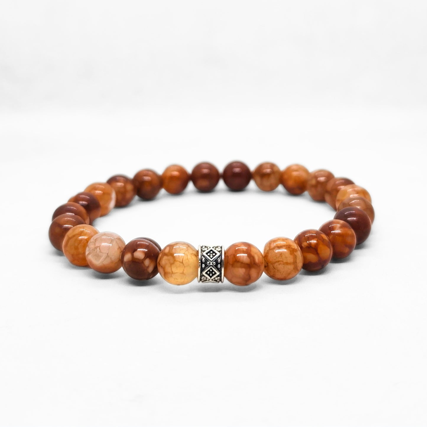 Men's brown beaded bracelet with warm orange and amber tones and silver center