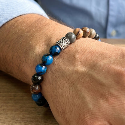 Natural Agate Stone - G-23 Bracelet featuring blue and brown beads with a decorative silver spacer, worn on a man's wrist.