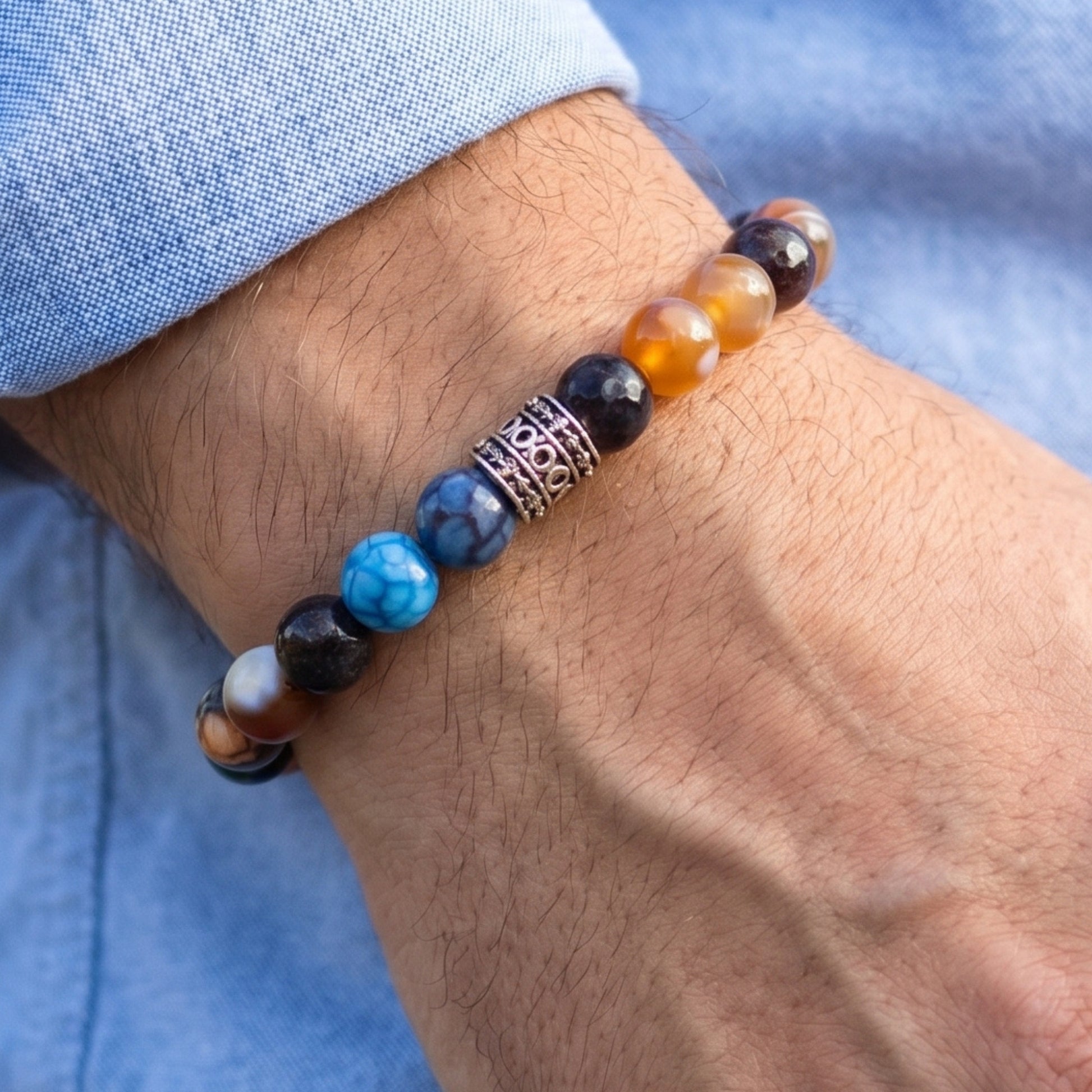Natural Agate Stone G-25 Bracelet by Overpowered Accessories features colorful beads and a decorative metal accent on a wrist