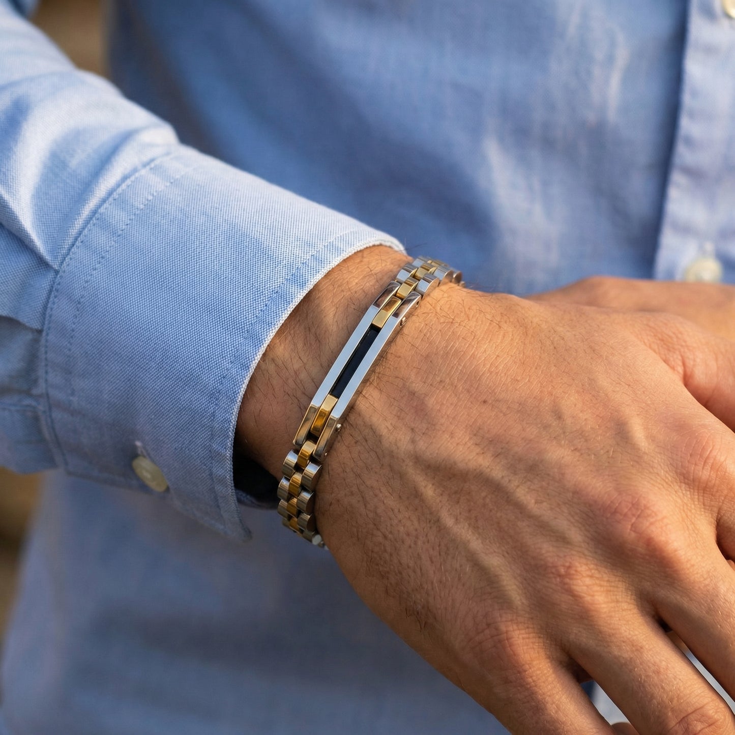 Tri-Color Silver, Gold, & Black Stainless Steel B-85 Bracelet on a man's wrist, showcasing a stylish design with a mix of met