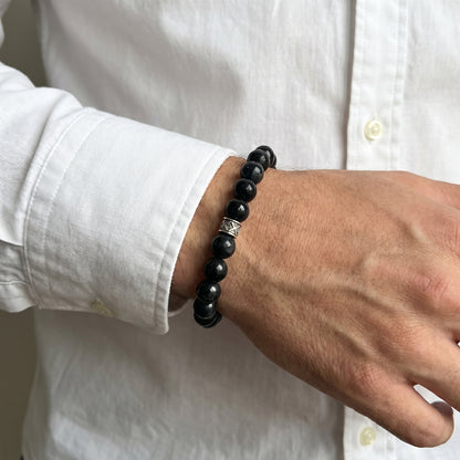 G-15 Natural Black Onyx & Stainless Steel Executive Bracelet on a man's wrist, featuring black beads and a silver accent.