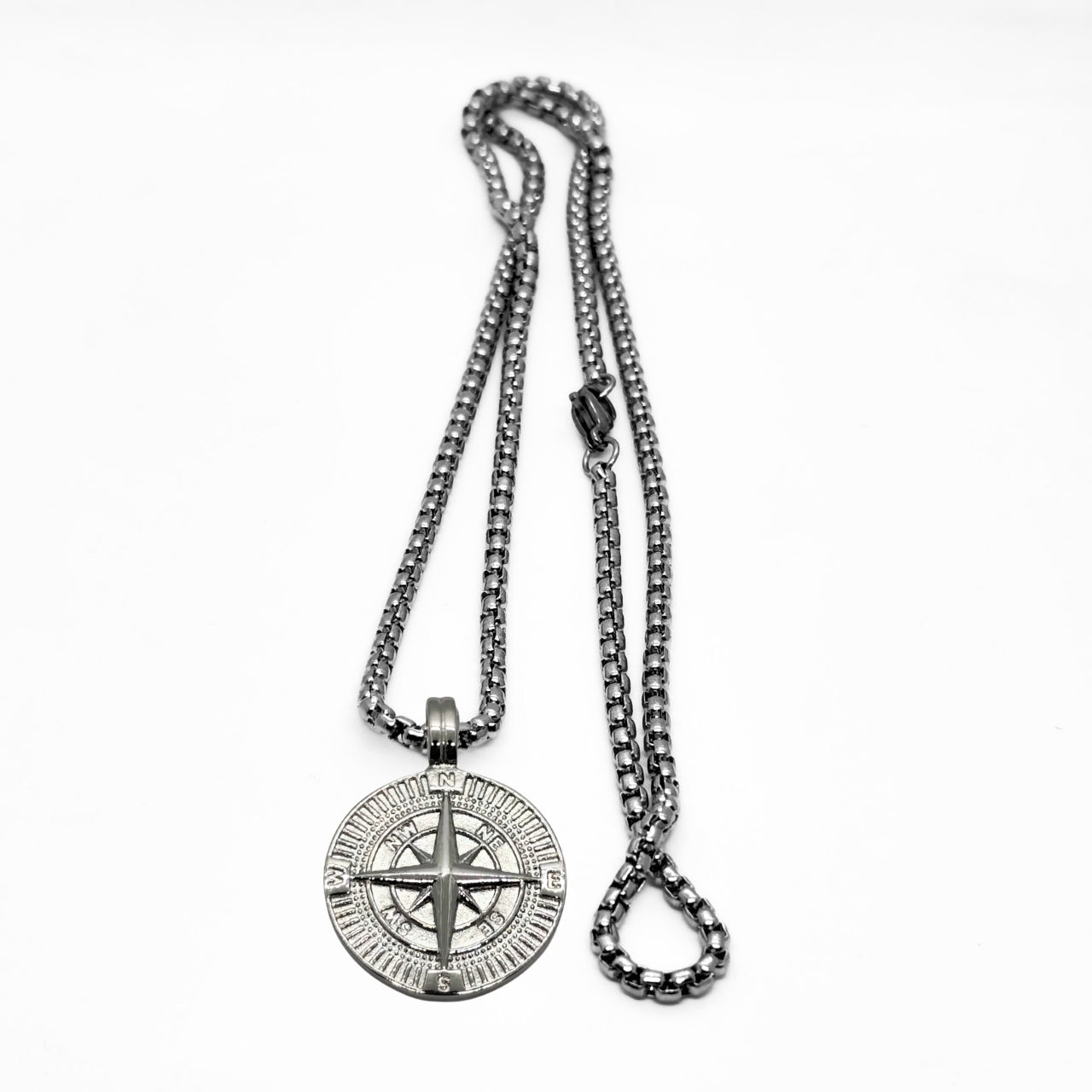 Silver steel compass pendant necklace with a detailed compass design and a sturdy chain, from Overpowered Accessories.