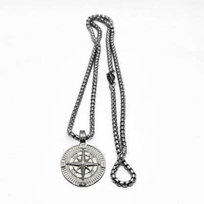 Silver steel compass pendant necklace with a detailed compass design and a sturdy chain, from Overpowered Accessories.