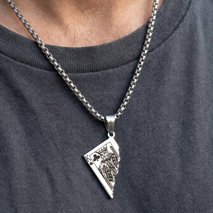 Silver King Card Pendant necklace on a chain, worn on a gray shirt, featuring intricate card design details.
