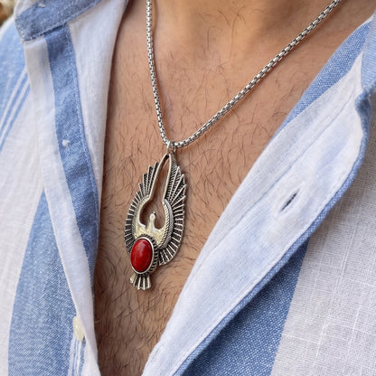 Eagle pendant necklace with silver-toned wings and red oval stone on metal chain