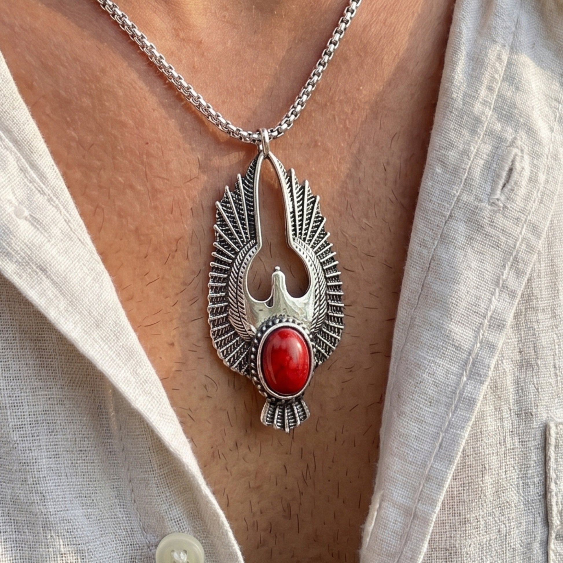 Eagle pendant necklace with red oval stone center and silver-tone textured wings