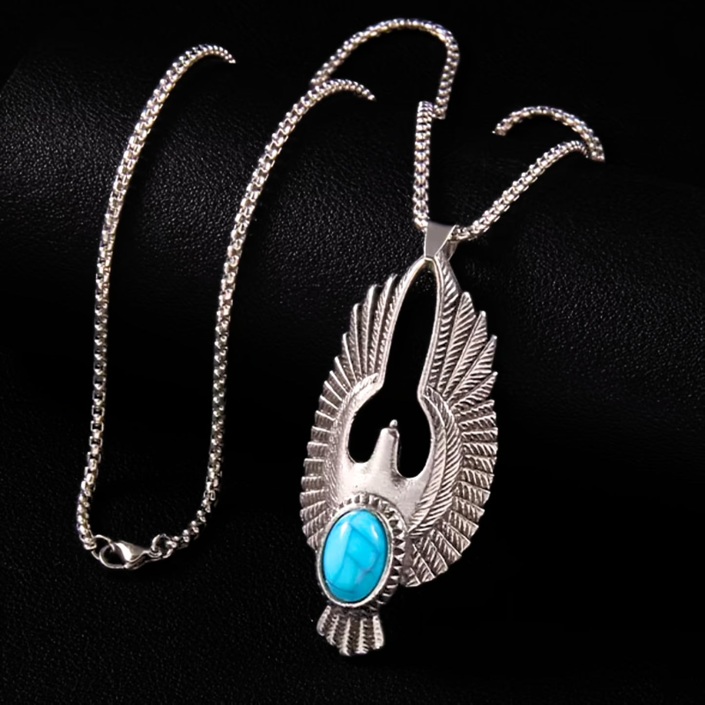 Silver eagle pendant necklace featuring turquoise stone and feathered wing details