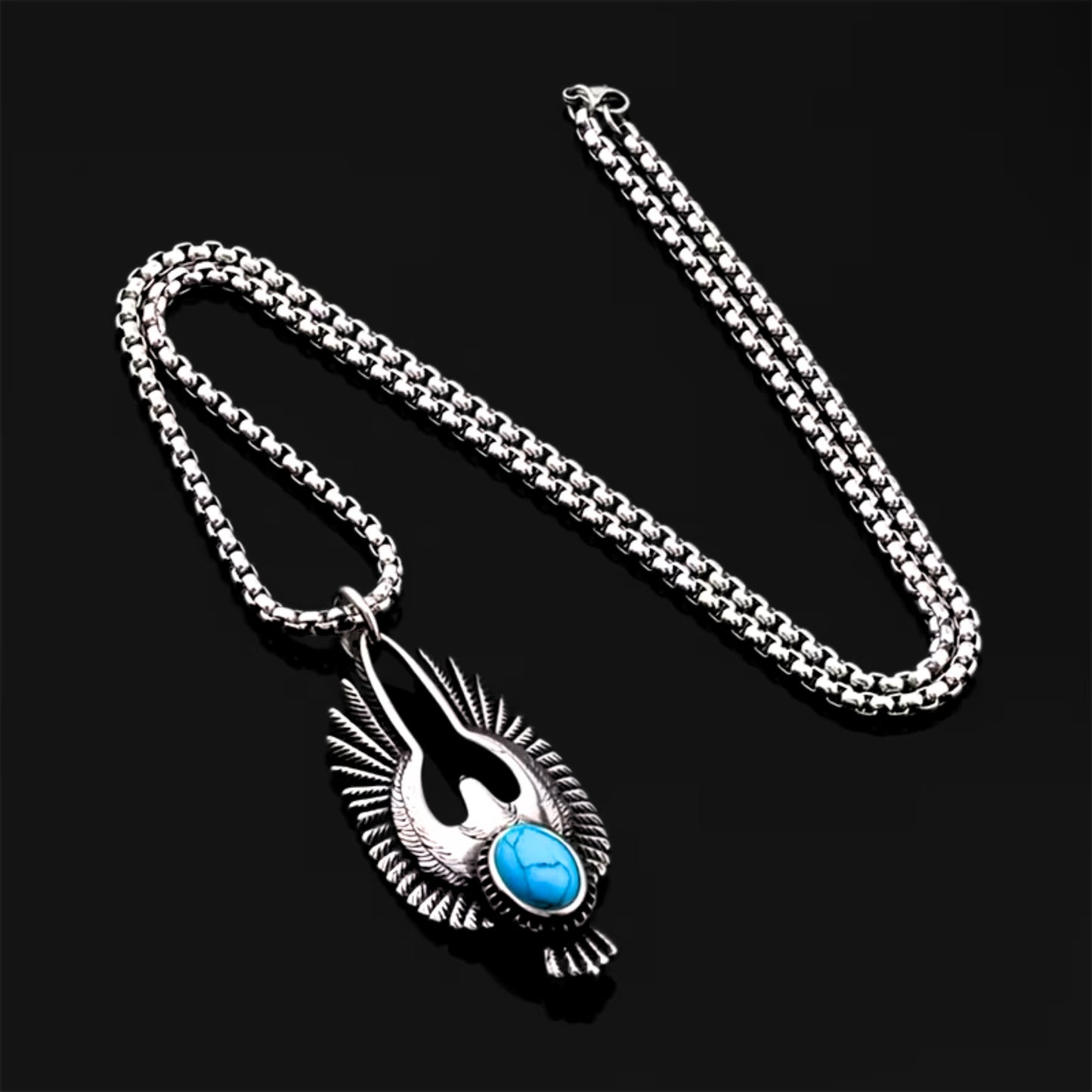 Silver eagle pendant necklace with textured wings and turquoise oval stone on a chain