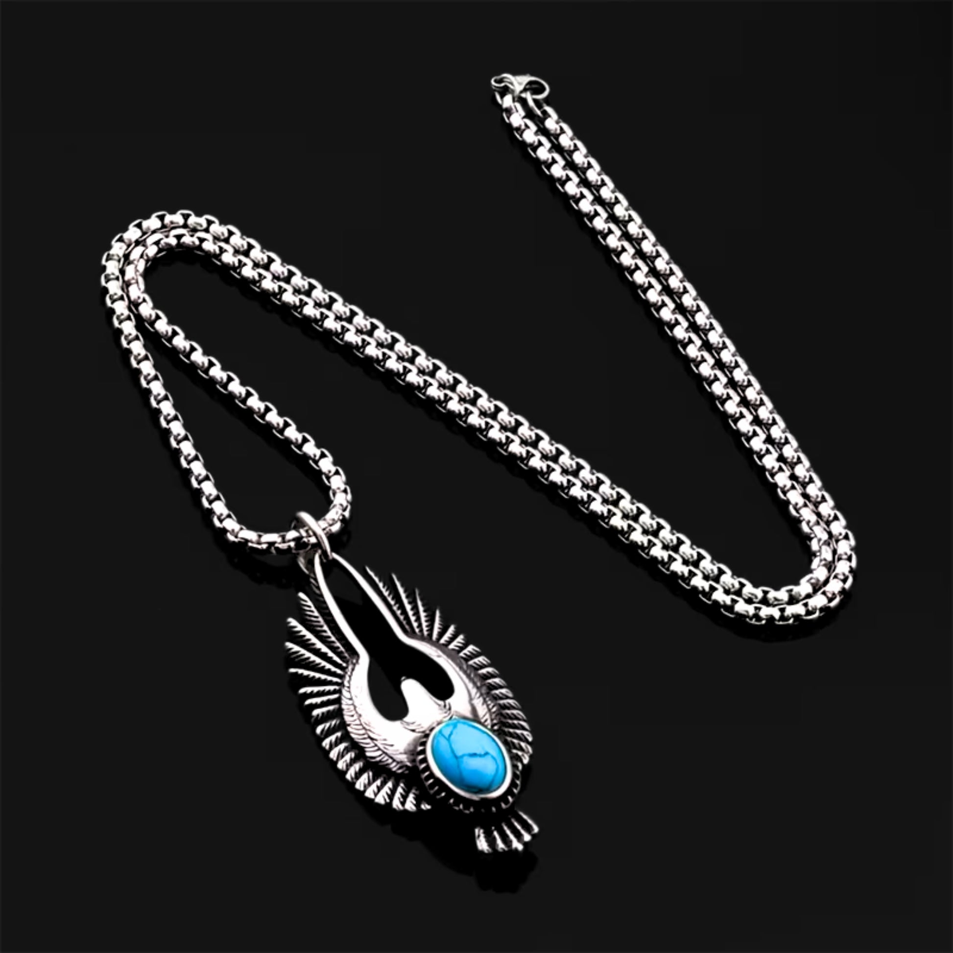 Silver eagle pendant necklace with textured wings and turquoise oval stone on a chain