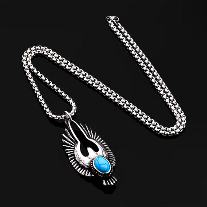 Silver eagle pendant necklace with textured wings and turquoise oval stone on a chain