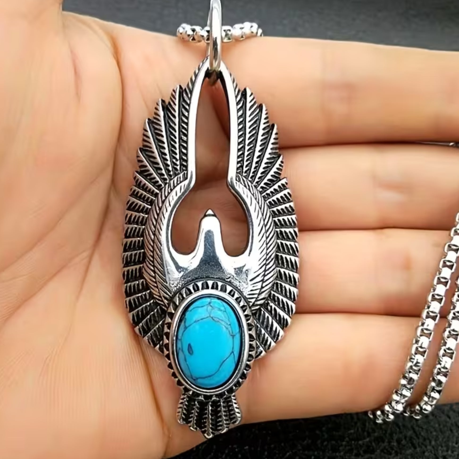 Silver eagle pendant necklace with turquoise oval stone, worn on a chain