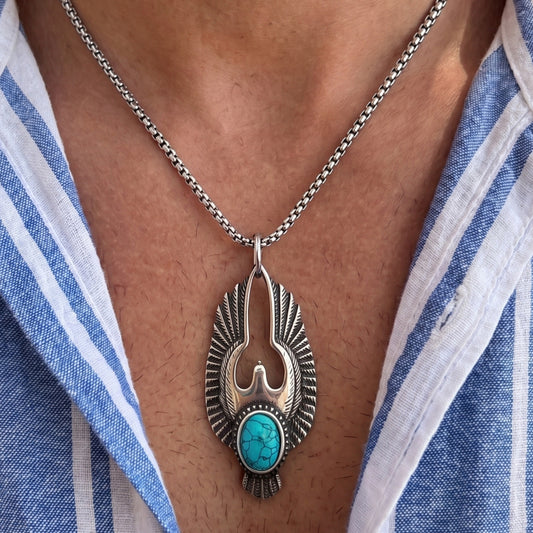 Silver eagle pendant necklace with turquoise stone on a man’s neck