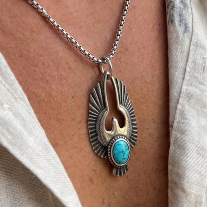 Silver eagle pendant necklace with turquoise cabochon stone and textured feather wings