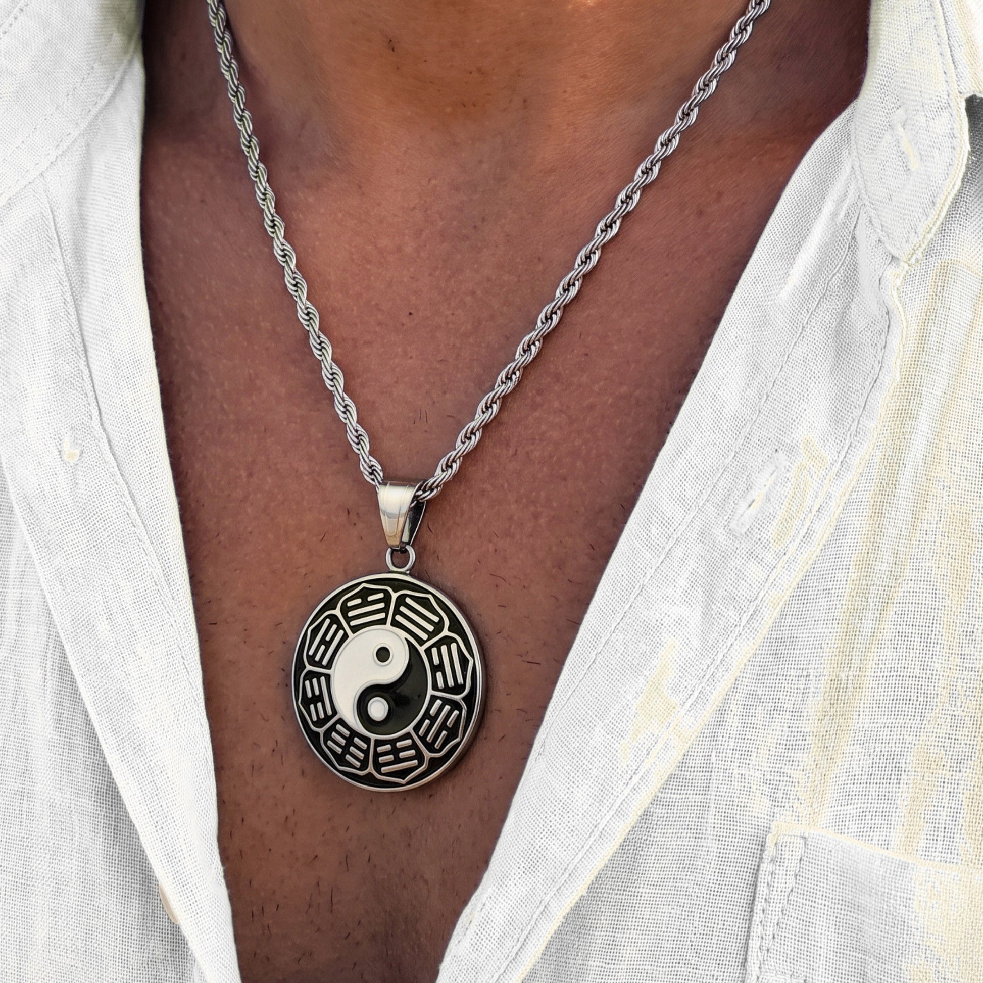 Silver yin-yang pendant necklace with round pendant disc and braided chain, clasp at top