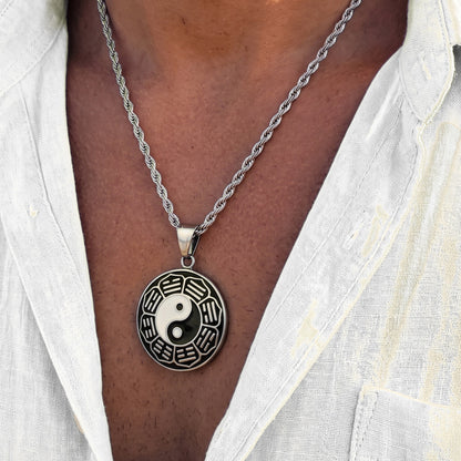Silver yin-yang pendant necklace with round pendant disc and braided chain, clasp at top