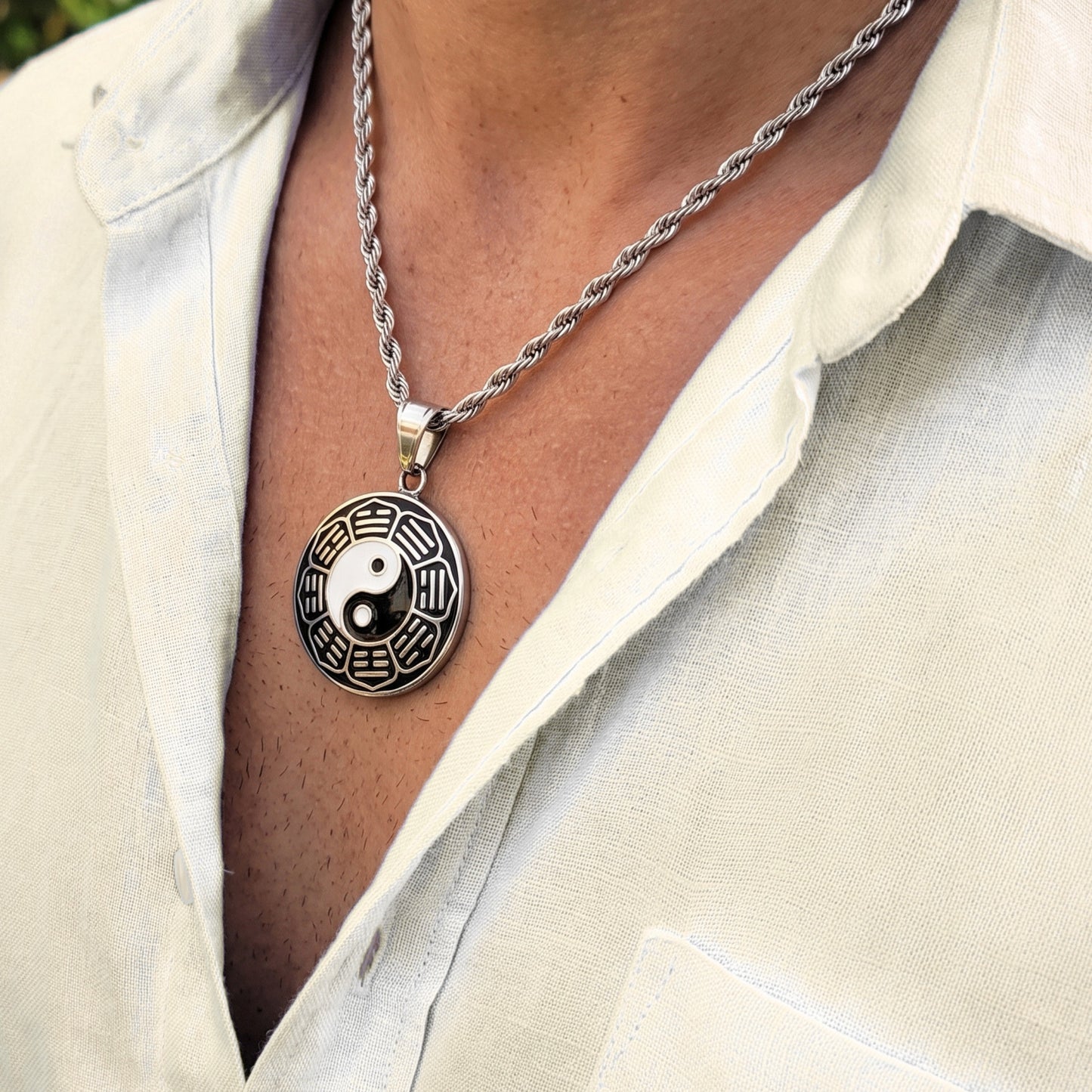 Silver yin-yang pendant necklace with round yin-yang charm centered on silver chain