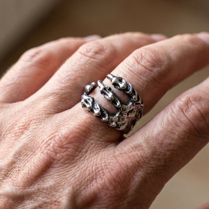 Ultra-Thin Zinc Alloy R-3 Ring by Overpowered Accessories, featuring a unique skeletal hand design on a finger.