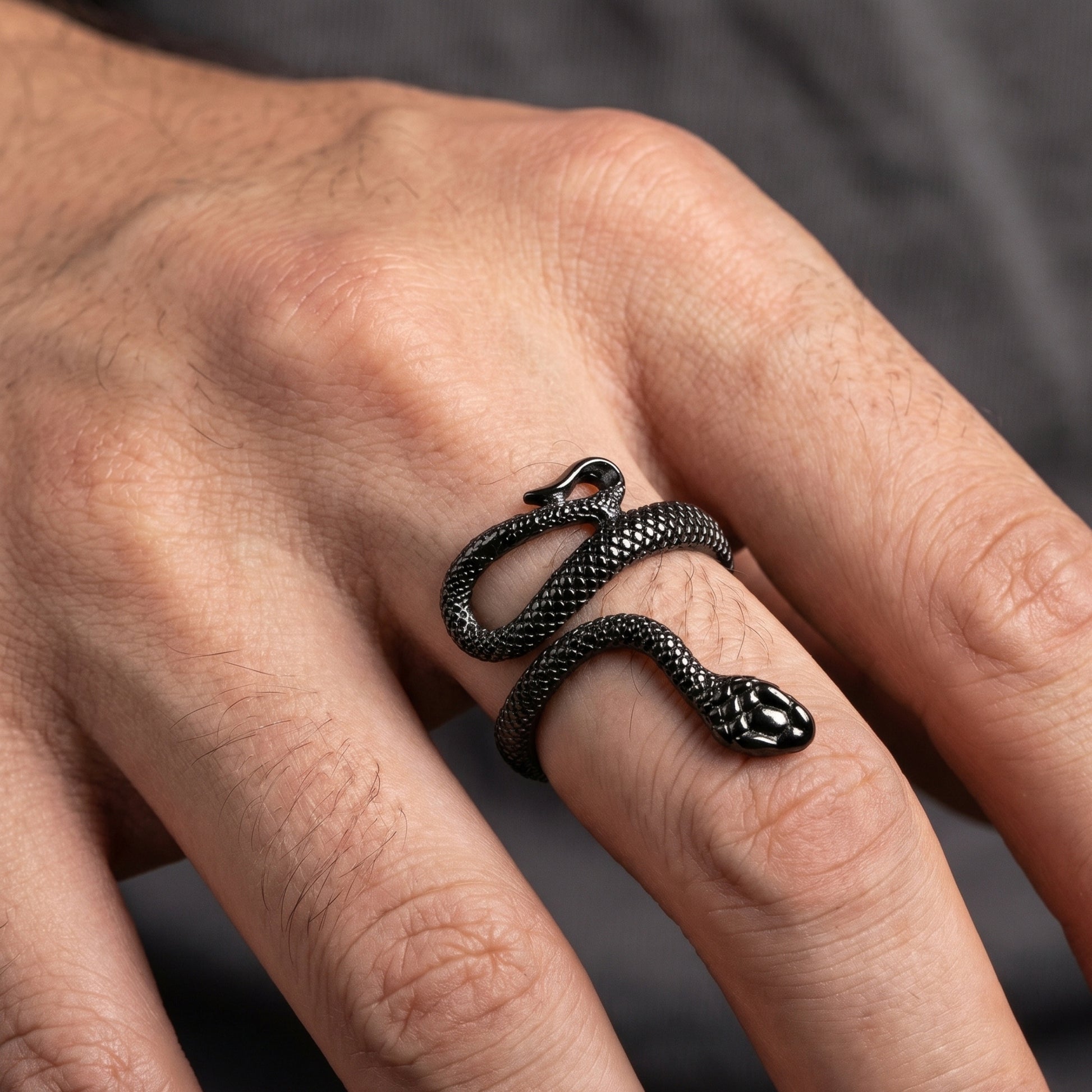 Bold Snake Design Zinc Alloy R-6 Ring from Overpowered Accessories featuring a detailed snake design wrapped around a finger.