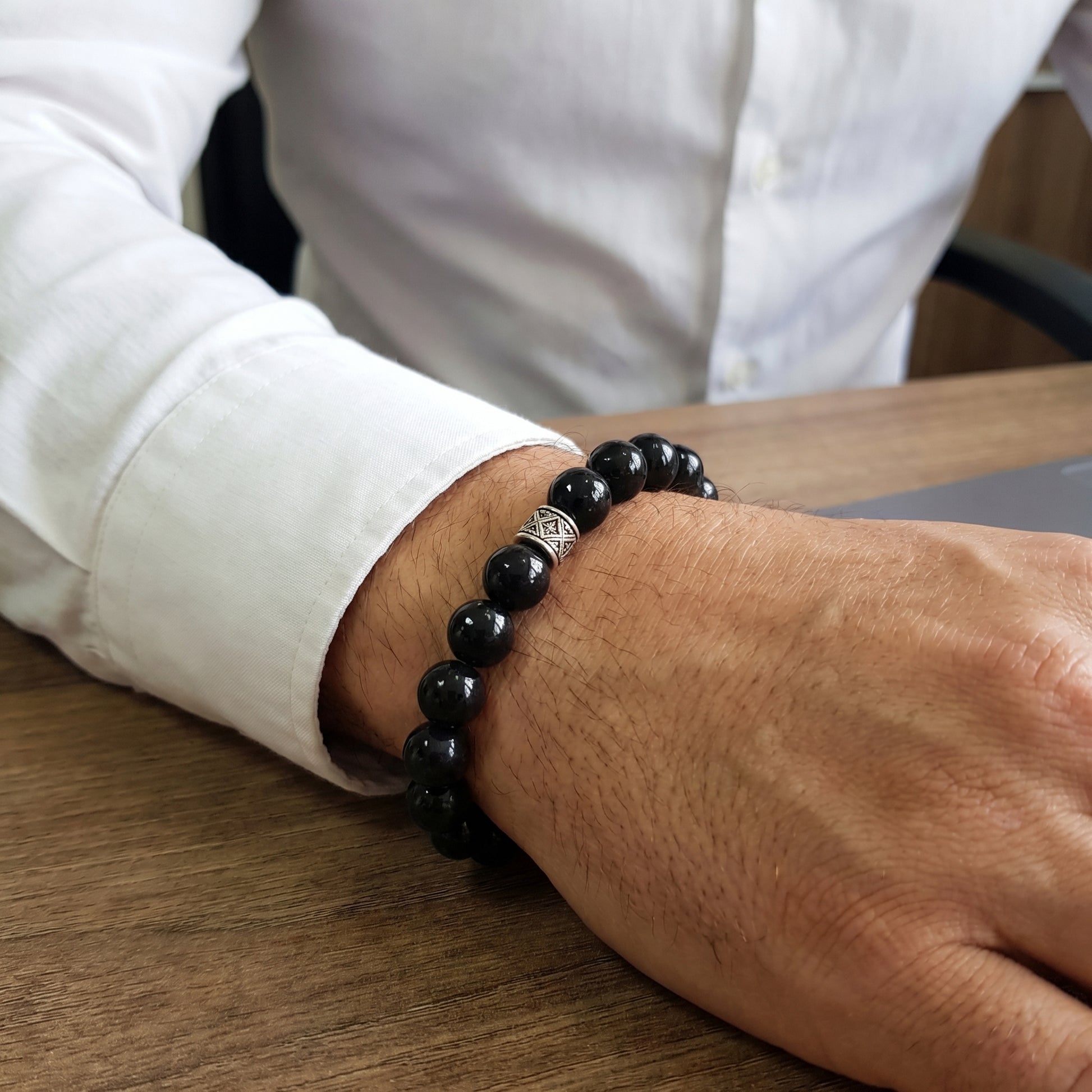 G-15 Natural Black Onyx & Stainless Steel Executive Bracelet on a man's wrist, featuring polished black onyx beads and a silv