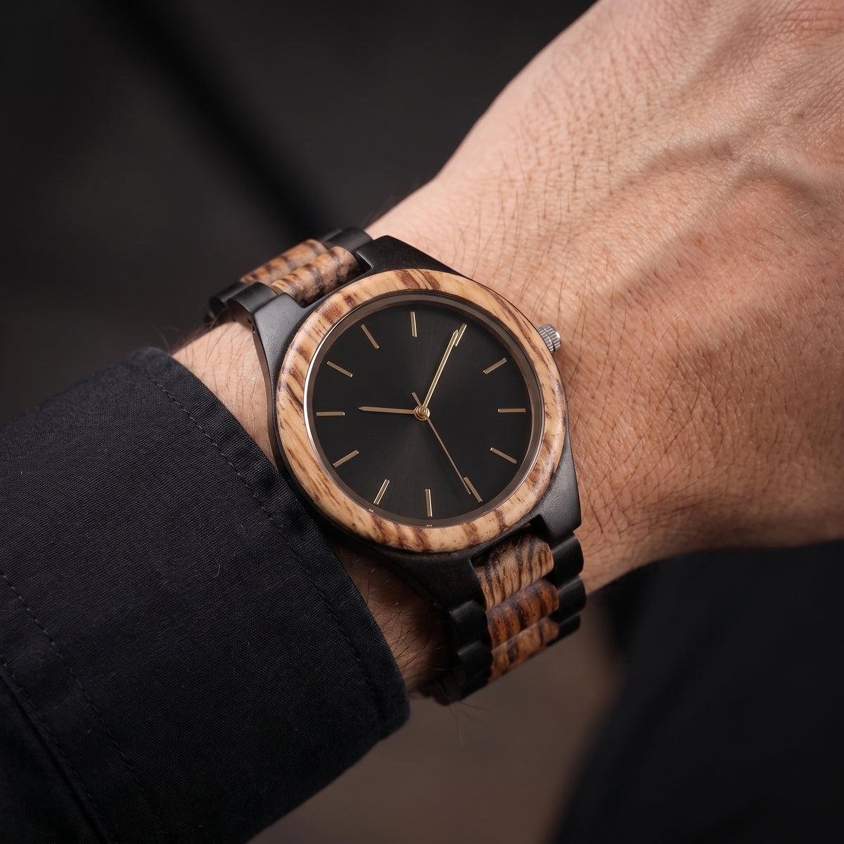 Men's wooden wristwatch on wrist, round wood bezel, black dial, dark braided strap, Overpowered Accessories
