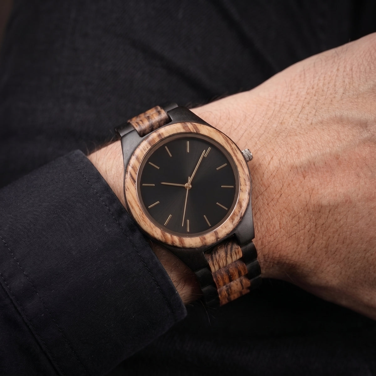 Men's wooden wristwatch on wrist, round wood case, black dial, dark wooden link band, Overpowered Accessories