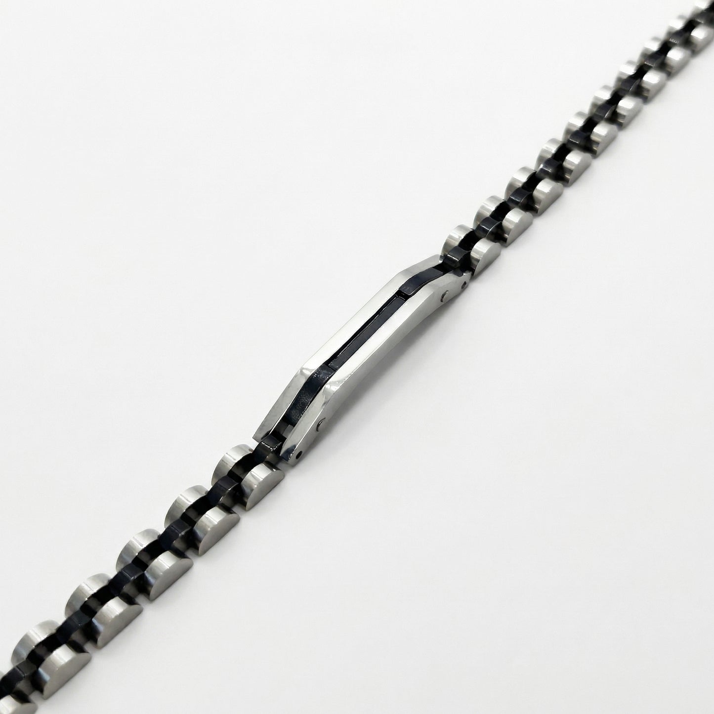 Two-tone silver and black stainless steel B-84 bracelet for men, featuring a sleek, modern design with alternating links.
