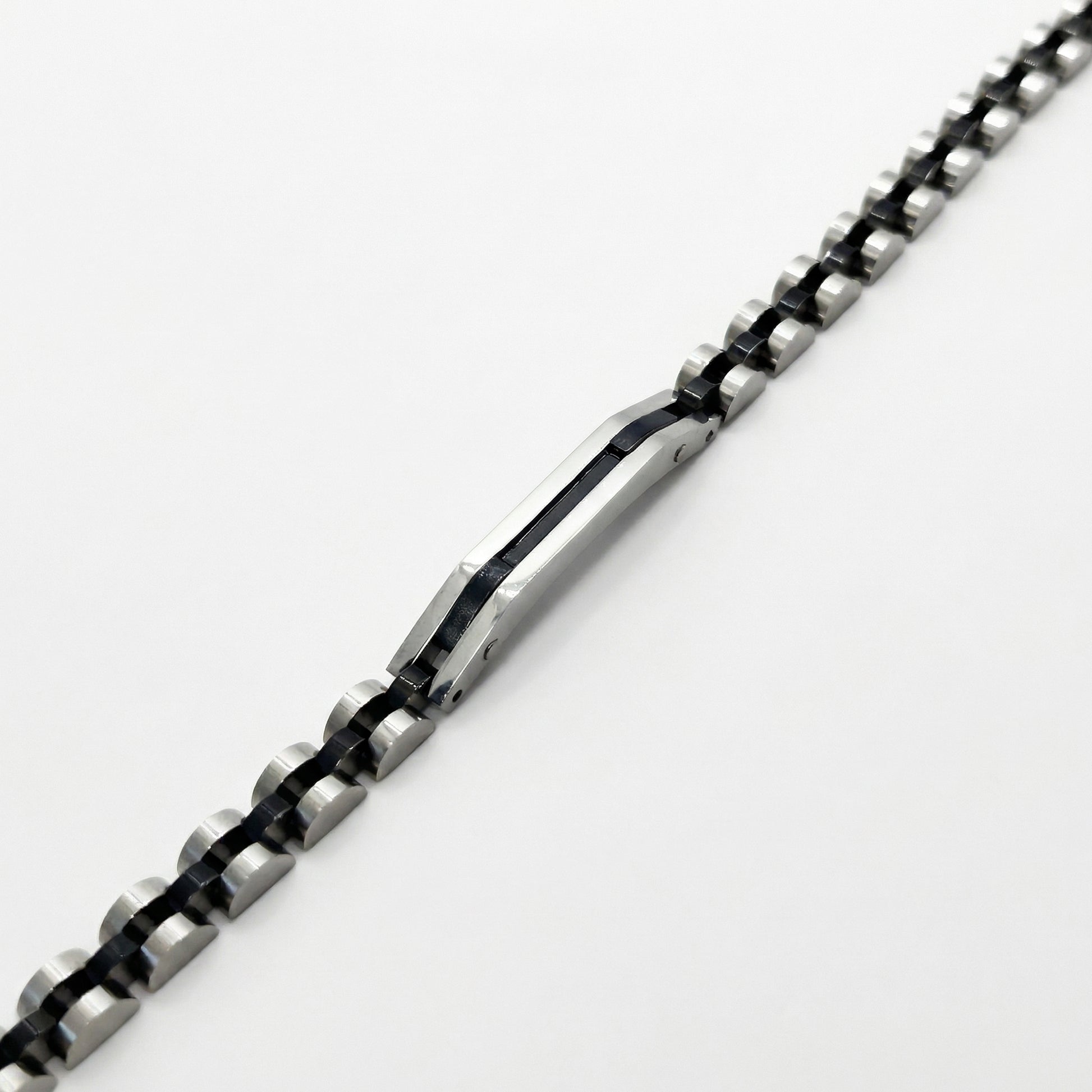 Two-tone silver and black stainless steel B-84 bracelet for men, featuring a sleek, modern design with alternating links.