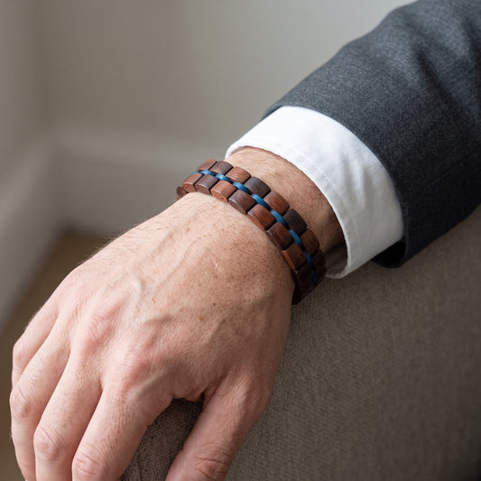 Men's adjustable rosewood bracelet with dark beads and blue braided detail