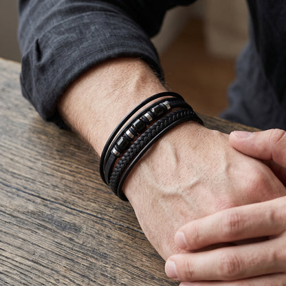 Men's black leather bracelet with braided weave and metal bead accents, adjustable fit