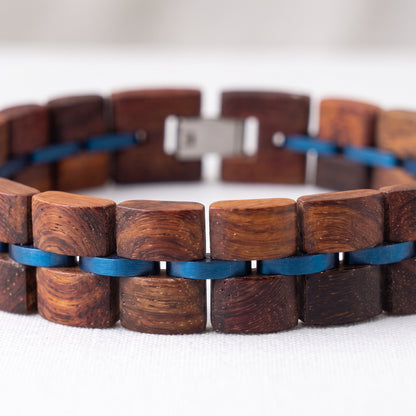 Rosewood wood block bracelet laid flat, alternating brown blocks with blue inlay links, Overpowered Accessories