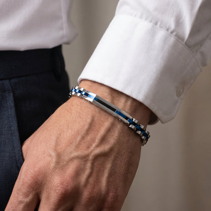 Stainless steel bracelet with blue accents worn on a man's wrist
