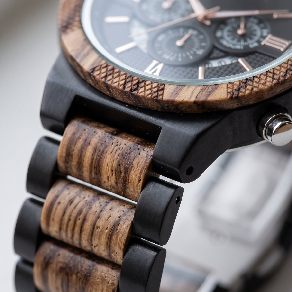 Men's zebrawood and ebony wood watch strap close-up with black case and side button, Overpowered Accessories