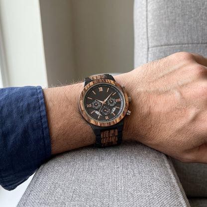 Men's zebrawood and ebony wood wristwatch on wrist with black dial and multiple chronograph subdials, Overpowered Accessories