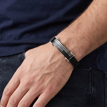 Men's black stainless steel ID bracelet with silver bar accents on wrist