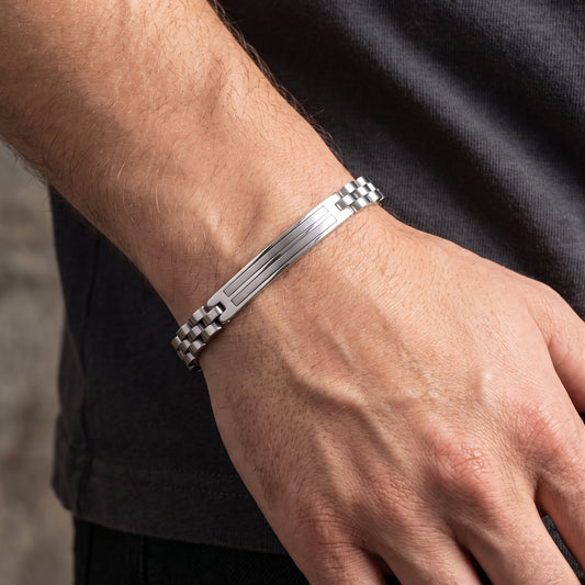 Silver stainless steel bracelet with striped center band and box clasp