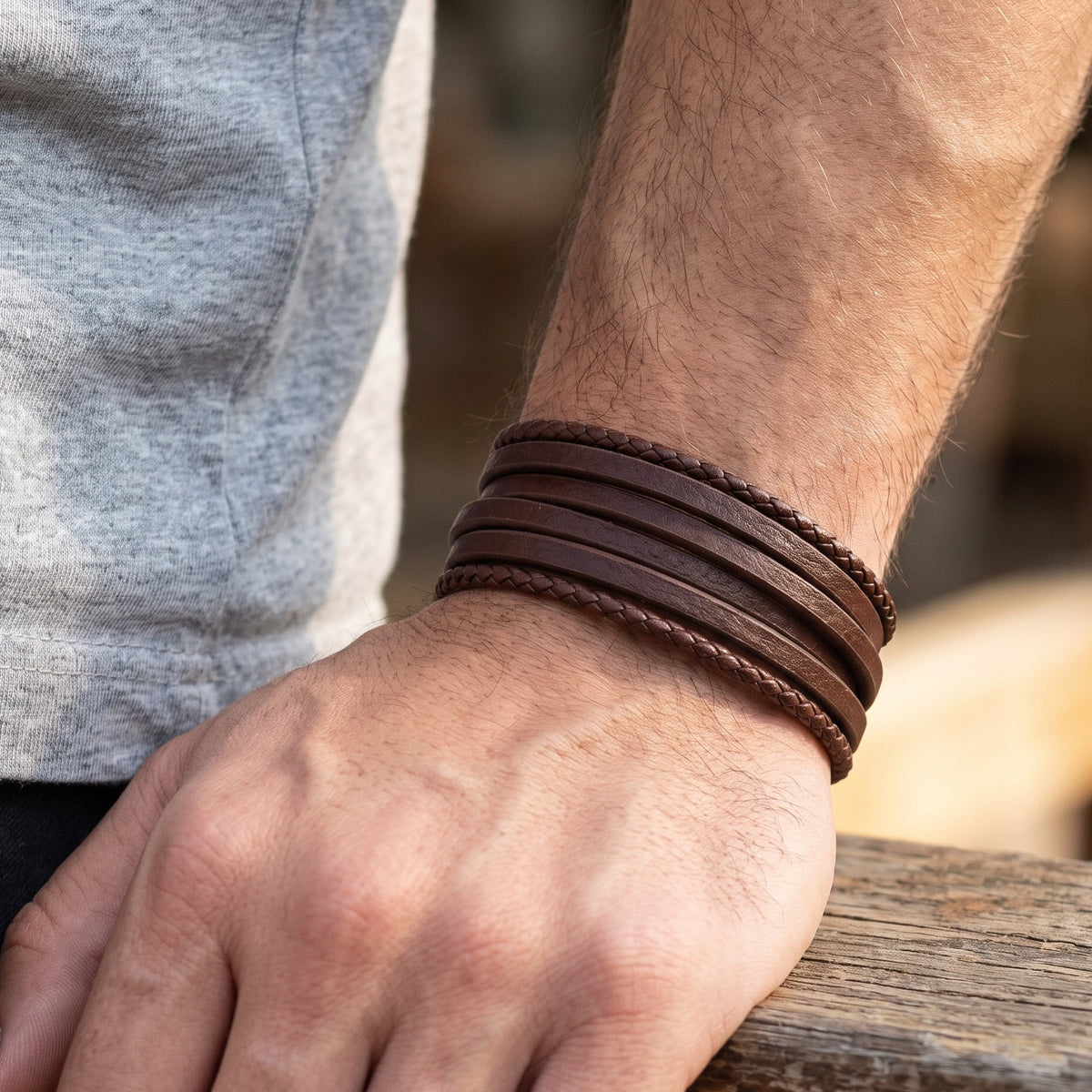 Men's brown leather multi-wrap bracelet with stitched bands on wrist