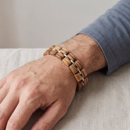 Natural zebrawood bead bracelet on wrist with silver metal accents, Overpowered Accessories