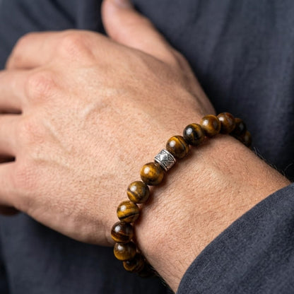 Men's Vigilant Vision Bundle G-8 SG-001 featuring a tiger's eye bracelet with silver accents, worn on a hand.