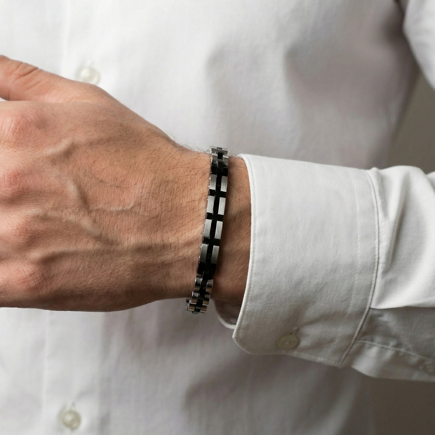Stainless steel duo bracelet with alternating silver and black square links on wrist