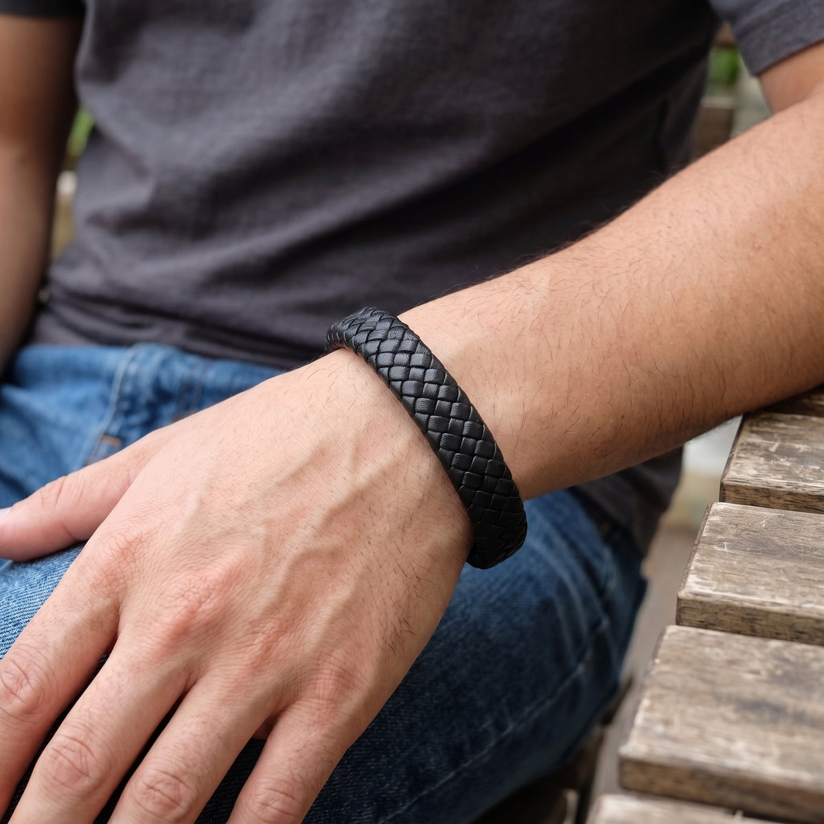 Men’s black braided leather bracelet with braided texture worn on forearm