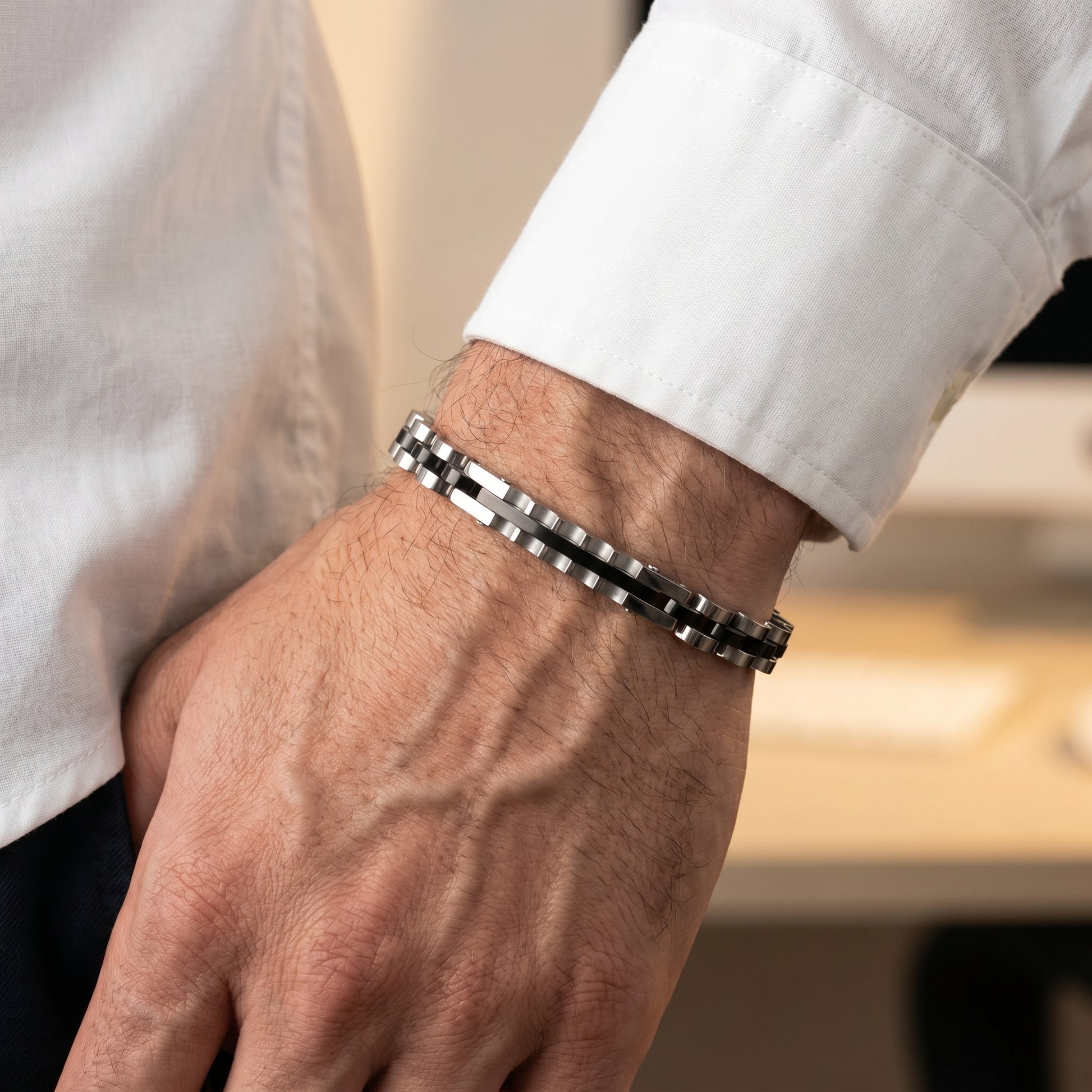 Elegant Silver & Black Stainless Steel B-133 Bracelet worn on a man's wrist, showcasing a stylish design and polished finish.
